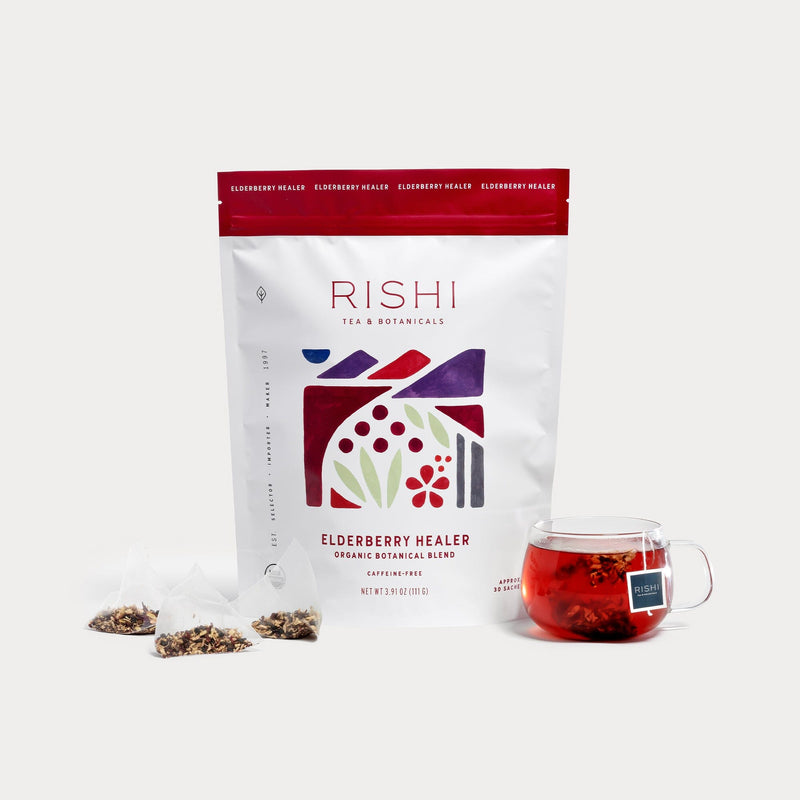A bag of Rishi Tea & Botanicals sits next to a cup, ready to enjoy.