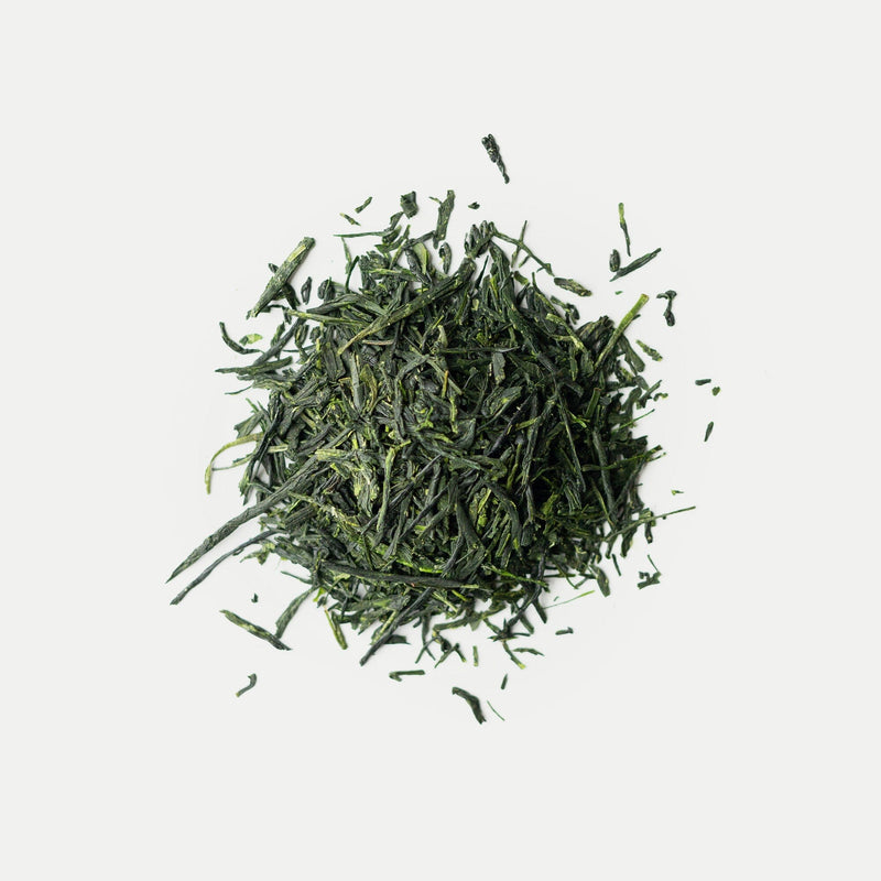 A pile of loose-leaf gyokuro from Rishi Tea & Botanicals, a prized Japanese tea, rests on a white background.